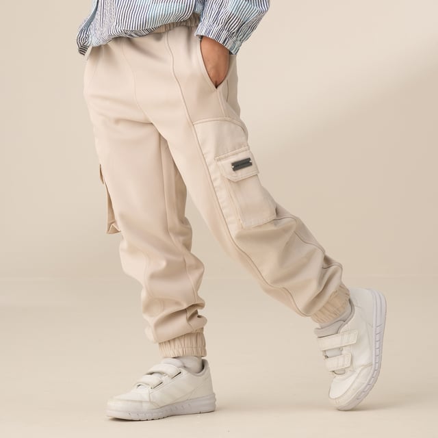 Refresh your everyday edit with these joggers! Featuring mixed fabrication and panelled cargo pockets. they combine a clean. streamlined look with a sports luxe vibe.