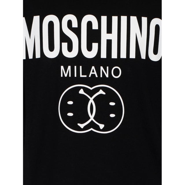 The Moschino Milano Double Smiley Black T-Shirt combines bold style with everyday comfort. Crafted from soft, high-quality fabric, this tee features the iconic double smiley graphic that adds a playful yet edgy touch to your wardrobe. Perfect for casual outings or making a statement, its sleek black color pairs effortlessly with any outfit. Elevate your look with a piece that reflects both contemporary fashion and Moschino's signature creativity. This t-shirt is a must-have for those who want to stand out while enjoying all-day comfort., Made in Portugal, 100% Cotton