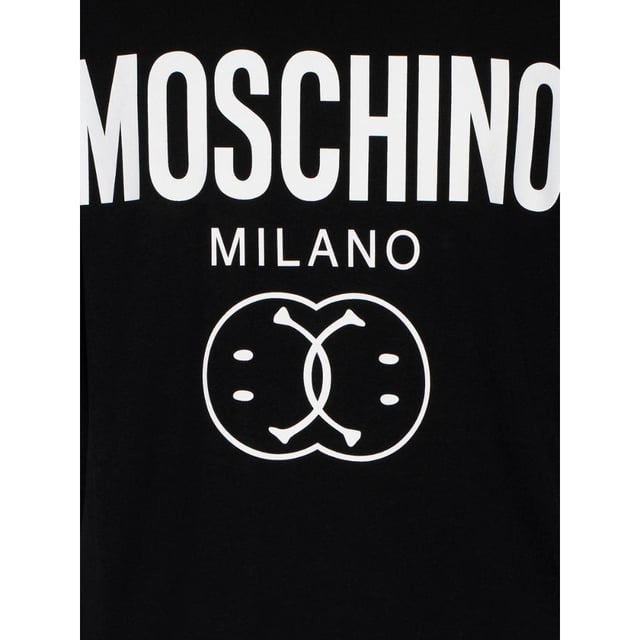 Elevate your casual wardrobe with the Moschino Bold Double Smiley Logo Black T-Shirt. Crafted from premium fabric, this tee offers exceptional comfort and durability for everyday wear. Its striking double smiley logo boldly expresses your playful style while maintaining a sleek, modern look. Perfect for pairing with jeans or layering under jackets, this versatile black t-shirt adds a touch of designer flair to any outfit. Make a confident statement effortlessly with Moschino's iconic design that blends fun and fashion seamlessly. Made in Portugal, 100% Cotton