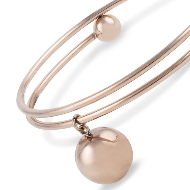 Budapest Bracelet: Geometric sophistication in rose gold.\n\n This double-ring bracelet stands out for its clean, contemporary design, featuring a dangling sphere that adds movement and style. Crafted from steel and rhodium-plated with a rose gold finish, it combines elegance and durability for everyday wear with a modern touch.\n\n Details:\n - Made of high quality steel, firm and light.\n - Rhodium plating with a rose gold finish, offering a warm and sophisticated shine.\n - Open design with double-ring structure, easy to put on.\n - Decorative detail with hanging sphere and rounded ends.\n - Minimalist style with a modern twist, ideal for urban or elegant looks.\n\n A versatile and striking women's bracelet that adds character without sacrificing simplicity. Perfect for those looking for designer pieces with a refined finish.\n Measures: Diameter: 6.4 cm\n Composition: Stainless steel, rhodium plating\n Care:\nAvoid contact with perfumes and abrasive products.