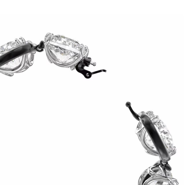 Combining mystery and whimsy, this cuff bracelet creates the illusion of floating stones. It is expertly crafted from a row of oversized cushion-cut clear crystals in an elegant claw setting. Pair it with sleek black evening gloves or a simple long-sleeved T-shirt to elevate your daytime look. Part of the Harmonia family, this bracelet was designed by creative director Giovanna Engelbert for Collection I. How to fasten and open: Place the bar with the rounded end at the widest point of the opposite gap and slide it into the narrower gap. Once in place, pull down the safety clasp at the top to secure the closure. To open, lift the safety clasp and slide the bar into the wider gap to release.\n Measures: Length (minimum - maximum): 16.5 - 22.7 cm\n Width: 1.7 cm\n Composition: Material: Crystals, Various metallic finishes\n Care:\nAvoid contact with creams, perfumes and detergents that may damage the product. To maintain its shine, we recommend cleaning it only with a soft cloth.