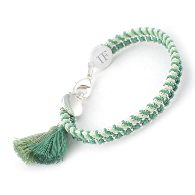 Santorini Bracelet by Ion Fiz: Handcrafted color with a designer stamp.\n\n Inspired by the freshness of the Mediterranean, this bracelet stands out for its combination of carefully interwoven textures and tones. The design blends nylon and cotton threads with a delicate zinc chain, creating a piece with a distinctive character and relaxed style.\n\n Details:\n - Hand-woven with nylon and cotton threads in various harmonious tones.\n - Lightweight zinc chain with shiny metallic finish.\n - Strong lobster clasp, easy to attach and secure.\n - Decorative textile tassel detail at the ends.\n - Metal pendant engraved with the firm's distinctive IF.\n\n A comfortable, creative, and distinctive bracelet, ideal for adding a distinctive and colorful touch to your everyday or seasonal looks.\n Measures: Diameter: 6 cm\n Composition: Nylon, Cotton, Zinc\n Care:\nAvoid contact with water, perfumes or abrasive products.