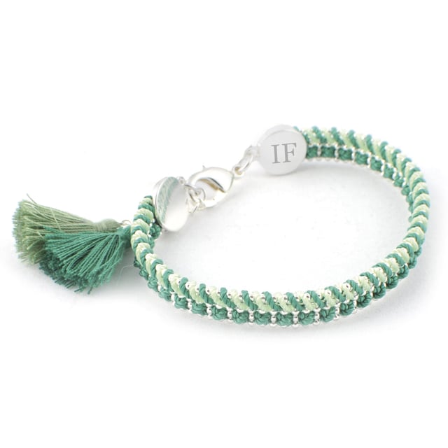Santorini Bracelet by Ion Fiz: Handcrafted color with a designer stamp.\n\n Inspired by the freshness of the Mediterranean, this bracelet stands out for its combination of carefully interwoven textures and tones. The design blends nylon and cotton threads with a delicate zinc chain, creating a piece with a distinctive character and relaxed style.\n\n Details:\n - Hand-woven with nylon and cotton threads in various harmonious tones.\n - Lightweight zinc chain with shiny metallic finish.\n - Strong lobster clasp, easy to attach and secure.\n - Decorative textile tassel detail at the ends.\n - Metal pendant engraved with the firm's distinctive IF.\n\n A comfortable, creative, and distinctive bracelet, ideal for adding a distinctive and colorful touch to your everyday or seasonal looks.\n Measures: Diameter: 6 cm\n Composition: Nylon, Cotton, Zinc\n Care:\nAvoid contact with water, perfumes or abrasive products.