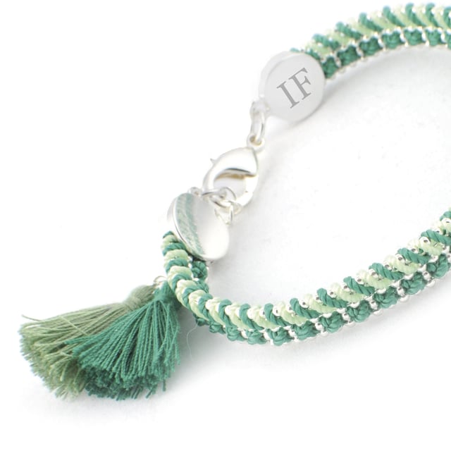 Santorini Bracelet by Ion Fiz: Handcrafted color with a designer stamp.\n\n Inspired by the freshness of the Mediterranean, this bracelet stands out for its combination of carefully interwoven textures and tones. The design blends nylon and cotton threads with a delicate zinc chain, creating a piece with a distinctive character and relaxed style.\n\n Details:\n - Hand-woven with nylon and cotton threads in various harmonious tones.\n - Lightweight zinc chain with shiny metallic finish.\n - Strong lobster clasp, easy to attach and secure.\n - Decorative textile tassel detail at the ends.\n - Metal pendant engraved with the firm's distinctive IF.\n\n A comfortable, creative, and distinctive bracelet, ideal for adding a distinctive and colorful touch to your everyday or seasonal looks.\n Measures: Diameter: 6 cm\n Composition: Nylon, Cotton, Zinc\n Care:\nAvoid contact with water, perfumes or abrasive products.