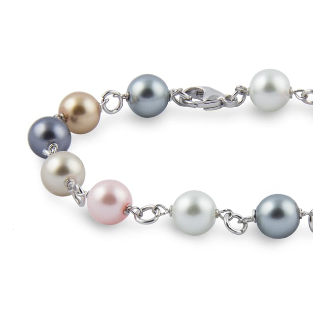 Pollença Bracelet with Majorcan Pearls: color and elegance with artisanal tradition.\n\n This bracelet celebrates variety and balance, combining Mallorcan pearls in multiple hues with a classic metal link design. Lightweight, lively, and refined, it's perfect for adding a special touch to any look.\n\n Details:\n - Handcrafted in Mallorca using the traditional method.\n - Majorcan pearls with a shiny finish and polished texture.\n - Varied shades that provide dynamism and sophistication.\n - Threaded with metal links that provide structure and movement.\n - Secure and easy-to-attach lobster clasp.\n\n A vibrant and versatile piece of jewelry, ideal for those who enjoy handcrafted details and are looking for an accessory that goes with everything.\n Measures: Length: 21 cm\n Composition: Pearls, Metal\n Care:\nAvoid contact with perfumes, creams and chemicals.