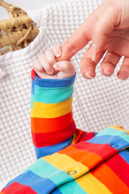 Long sleeve baby romper with centre front popper fastening and turn down leg cuffs for extended wear.GOTS Organic Certified by Soil Association Certification Licence Number DK22283