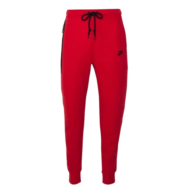 Nike - Schwarze Jogginghose Mit Verschweißten Reißverschlüssen Und Rot Erleben Sie Komfort und Style mit der Nike Black Taped Zips Red Sweatpants. Sie besteht aus einem weichen Materialmix aus 53 % Baumwolle und 47 % Polyester für Strapazierfähigkeit und Atmungsaktivität. Der elastische Bund und die Bündchen sowie der Kordelzug sorgen für einen sicheren, verstellbaren Sitz. Die Slim-Fit-Jogginghose mit schmal zulaufendem Bein und regulärer Länge bietet eine moderne Silhouette. Zu den praktischen Details gehören zwei Fronttaschen, eine davon mit Reißverschluss zur sicheren Aufbewahrung wichtiger Utensilien, und das ikonische Nike Swoosh-Logo auf der linken Hüfte verleiht ihr einen sportlichen Touch. Diese Jogginghose ist perfekt für Freizeit und Training und vereint Funktionalität mit elegantem Design