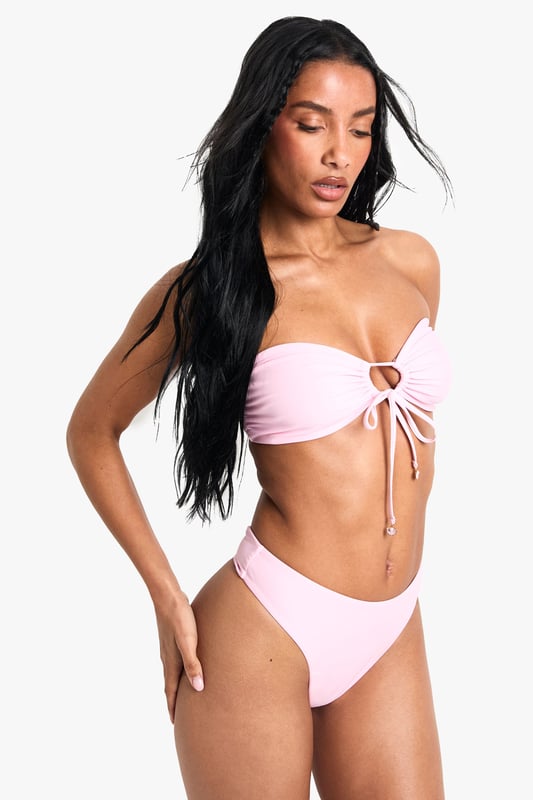 Strapless bandeau top with elegant pearl embellishment at centre front
        Adjustable tie detail for a customised fit and stylish look
        Knitted fabric offers comfortable stretch and shape retention
        Mid-rise bikini bottoms with clean, seamless finish
        Versatile two-piece design perfect for mixing and matching with other swimwear
    
    Make a statement poolside with this chic bandeau bikini set from Boohoo. The striking pearl detail adds a touch of glamour to this otherwise minimalist design, whilst the adjustable tie front allows you to create your perfect fit. The knitted fabric moulds beautifully to your figure, ensuring both comfort and style throughout your holiday. Pair with oversized sunglasses and a flowing kimono for casual beach days, or style with a sheer maxi skirt and metallic sandals for sunset cocktails at the beach bar. This versatile two-piece works brilliantly as a foundation for your holiday wardrobe, easily transitioning from daytime sunbathing to evening promenade strolls with just a few accessory changes.