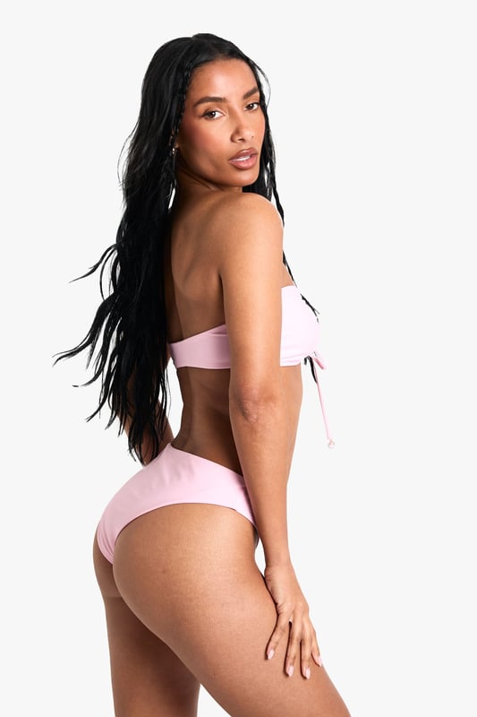 Strapless bandeau top with elegant pearl embellishment at centre front
        Adjustable tie detail for a customised fit and stylish look
        Knitted fabric offers comfortable stretch and shape retention
        Mid-rise bikini bottoms with clean, seamless finish
        Versatile two-piece design perfect for mixing and matching with other swimwear
    
    Make a statement poolside with this chic bandeau bikini set from Boohoo. The striking pearl detail adds a touch of glamour to this otherwise minimalist design, whilst the adjustable tie front allows you to create your perfect fit. The knitted fabric moulds beautifully to your figure, ensuring both comfort and style throughout your holiday. Pair with oversized sunglasses and a flowing kimono for casual beach days, or style with a sheer maxi skirt and metallic sandals for sunset cocktails at the beach bar. This versatile two-piece works brilliantly as a foundation for your holiday wardrobe, easily transitioning from daytime sunbathing to evening promenade strolls with just a few accessory changes.