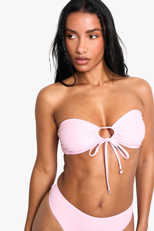 Strapless bandeau top with elegant pearl embellishment at centre front
        Adjustable tie detail for a customised fit and stylish look
        Knitted fabric offers comfortable stretch and shape retention
        Mid-rise bikini bottoms with clean, seamless finish
        Versatile two-piece design perfect for mixing and matching with other swimwear
    
    Make a statement poolside with this chic bandeau bikini set from Boohoo. The striking pearl detail adds a touch of glamour to this otherwise minimalist design, whilst the adjustable tie front allows you to create your perfect fit. The knitted fabric moulds beautifully to your figure, ensuring both comfort and style throughout your holiday. Pair with oversized sunglasses and a flowing kimono for casual beach days, or style with a sheer maxi skirt and metallic sandals for sunset cocktails at the beach bar. This versatile two-piece works brilliantly as a foundation for your holiday wardrobe, easily transitioning from daytime sunbathing to evening promenade strolls with just a few accessory changes.