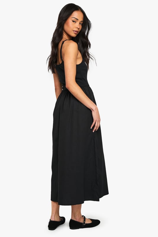 Flattering scoop neckline for a feminine touch
        Sleeveless design perfect for warmer days
        Fitted bodice with a flared skirt for a classic silhouette
        Midi length offers versatile styling options
        Soft cotton blend fabric ensures all-day comfort
    
    This charming jersey dress from Boohoo is the epitome of effortless style. The scoop neckline and sleeveless cut create a graceful look, while the fitted bodice smoothly transitions into a flared skirt, crafting a timeless silhouette. The midi length strikes the perfect balance between casual and chic, making it suitable for various occasions. Style it with flat sandals and a denim jacket for a relaxed daytime look, or dress it up with statement earrings and strappy heels for evening drinks. The versatile design allows for easy layering - throw on a cropped cardigan for cooler evenings or pair it with trainers for a trendy, laid-back vibe. This dress is a wardrobe essential that will take you from family gatherings to casual outings with friends, all while keeping you comfortable and stylish.