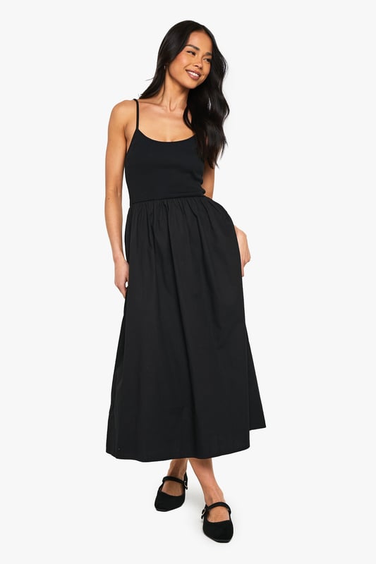 Flattering scoop neckline for a feminine touch
        Sleeveless design perfect for warmer days
        Fitted bodice with a flared skirt for a classic silhouette
        Midi length offers versatile styling options
        Soft cotton blend fabric ensures all-day comfort
    
    This charming jersey dress from Boohoo is the epitome of effortless style. The scoop neckline and sleeveless cut create a graceful look, while the fitted bodice smoothly transitions into a flared skirt, crafting a timeless silhouette. The midi length strikes the perfect balance between casual and chic, making it suitable for various occasions. Style it with flat sandals and a denim jacket for a relaxed daytime look, or dress it up with statement earrings and strappy heels for evening drinks. The versatile design allows for easy layering - throw on a cropped cardigan for cooler evenings or pair it with trainers for a trendy, laid-back vibe. This dress is a wardrobe essential that will take you from family gatherings to casual outings with friends, all while keeping you comfortable and stylish.