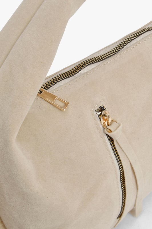 Faux suede hobo bag with statement fringe detailing along both sides
        Comfortable top handle design for easy carrying
        Practical zip closure to keep your essentials secure
        Stylish gold-tone hardware adding a touch of sophistication
        Spacious interior perfect for day-to-night essentials
    
    This boho-inspired faux suede bag brings effortless style to any outfit. The distinctive fringe detailing creates movement and texture, whilst the curved silhouette offers a relaxed yet fashionable aesthetic. Style with a fitted crop top and ribbed co-ord set for casual daytime outings, or pair with a flowing maxi dress and layered jewellery for evening drinks. The versatile design transitions seamlessly from office to dinner date, making it the perfect companion for busy days that turn into nights out. The practical size accommodates all your necessities without overwhelming your look, whilst the sturdy handle ensures comfortable carrying throughout the day. This Boohoo bag combines practicality with on-trend design for the fashion-forward woman.