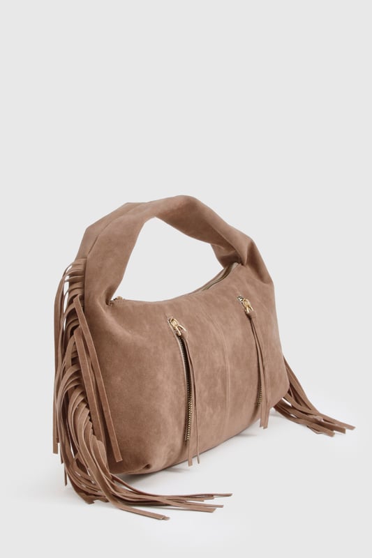 Faux suede hobo bag with statement fringe detailing along both sides
        Spacious main compartment with secure zip closure
        Twin decorative front zips with metallic pull tabs
        Comfortable curved top handle for easy carrying
        Soft-touch finish that mimics the luxurious feel of genuine suede
    
    This boho-inspired faux suede bag brings a touch of festival chic to your everyday wardrobe. The distinctive fringe detailing creates movement and texture, whilst the practical hobo silhouette offers ample space for your essentials. Style with white wide-leg trousers and a fitted top as shown for a balanced daytime look, or pair with a floaty midi dress and ankle boots for evening drinks. The versatile design transitions effortlessly from office to dinner date, making it the perfect companion for your busy social calendar. The curved handle sits comfortably on your shoulder, whilst the secure zip closure keeps your belongings safe. This Boohoo bag combines practicality with on-trend styling, perfect for the fashion-forward woman who values both form and function.