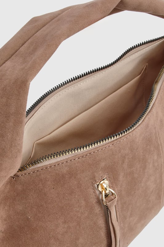 Faux suede hobo bag with statement fringe detailing along both sides
        Spacious main compartment with secure zip closure
        Twin decorative front zips with metallic pull tabs
        Comfortable curved top handle for easy carrying
        Soft-touch finish that mimics the luxurious feel of genuine suede
    
    This boho-inspired faux suede bag brings a touch of festival chic to your everyday wardrobe. The distinctive fringe detailing creates movement and texture, whilst the practical hobo silhouette offers ample space for your essentials. Style with white wide-leg trousers and a fitted top as shown for a balanced daytime look, or pair with a floaty midi dress and ankle boots for evening drinks. The versatile design transitions effortlessly from office to dinner date, making it the perfect companion for your busy social calendar. The curved handle sits comfortably on your shoulder, whilst the secure zip closure keeps your belongings safe. This Boohoo bag combines practicality with on-trend styling, perfect for the fashion-forward woman who values both form and function.