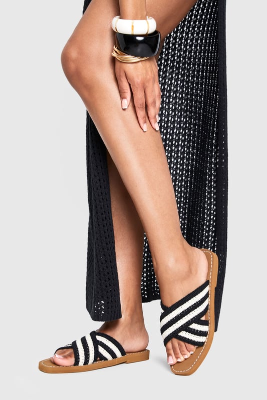 Distinctive crochet cross-over straps with bold stripe pattern
        Comfortable flat design with heel height between 0-2cm
        Cushioned footbed with contrast stitching detail
        Durable non-slip sole perfect for everyday wear
        Easy slip-on style for effortless summer dressing
    
    These crochet cross-over sandals bring a touch of artisanal charm to your summer wardrobe. The textured crochet finish creates visual interest while the contrasting stripe pattern adds a contemporary twist to a classic silhouette. Style them with a flowing maxi dress for a relaxed beach day, or pair with cropped trousers and a linen shirt for casual weekend brunches. The flat design ensures all-day comfort whether you're strolling through city streets or enjoying a coastal getaway. For festival season, match with denim shorts and a graphic tee, or dress them up with a breezy midi skirt for garden parties. Their versatility makes them an essential addition to your holiday packing list - perfect for transitioning from poolside lounging to impromptu evening walks along the promenade.