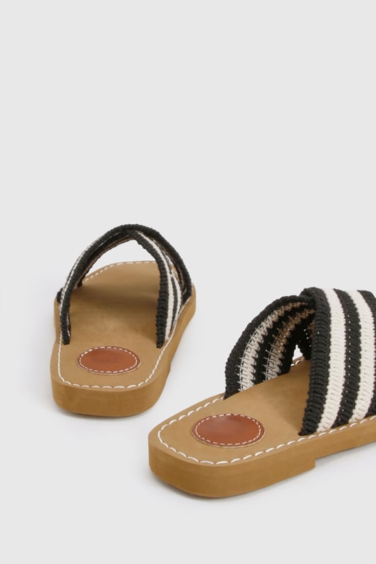 Distinctive crochet cross-over straps with bold stripe pattern
        Comfortable flat design with heel height between 0-2cm
        Cushioned footbed with contrast stitching detail
        Durable non-slip sole perfect for everyday wear
        Easy slip-on style for effortless summer dressing
    
    These crochet cross-over sandals bring a touch of artisanal charm to your summer wardrobe. The textured crochet finish creates visual interest while the contrasting stripe pattern adds a contemporary twist to a classic silhouette. Style them with a flowing maxi dress for a relaxed beach day, or pair with cropped trousers and a linen shirt for casual weekend brunches. The flat design ensures all-day comfort whether you're strolling through city streets or enjoying a coastal getaway. For festival season, match with denim shorts and a graphic tee, or dress them up with a breezy midi skirt for garden parties. Their versatility makes them an essential addition to your holiday packing list - perfect for transitioning from poolside lounging to impromptu evening walks along the promenade.
