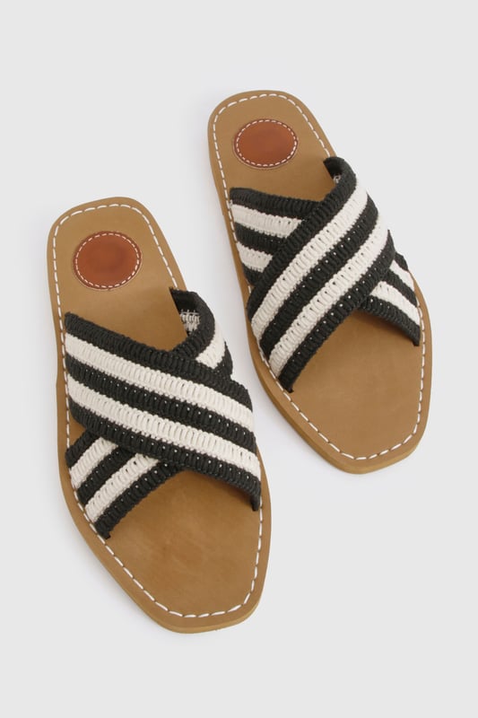 Distinctive crochet cross-over straps with bold stripe pattern
        Comfortable flat design with heel height between 0-2cm
        Cushioned footbed with contrast stitching detail
        Durable non-slip sole perfect for everyday wear
        Easy slip-on style for effortless summer dressing
    
    These crochet cross-over sandals bring a touch of artisanal charm to your summer wardrobe. The textured crochet finish creates visual interest while the contrasting stripe pattern adds a contemporary twist to a classic silhouette. Style them with a flowing maxi dress for a relaxed beach day, or pair with cropped trousers and a linen shirt for casual weekend brunches. The flat design ensures all-day comfort whether you're strolling through city streets or enjoying a coastal getaway. For festival season, match with denim shorts and a graphic tee, or dress them up with a breezy midi skirt for garden parties. Their versatility makes them an essential addition to your holiday packing list - perfect for transitioning from poolside lounging to impromptu evening walks along the promenade.