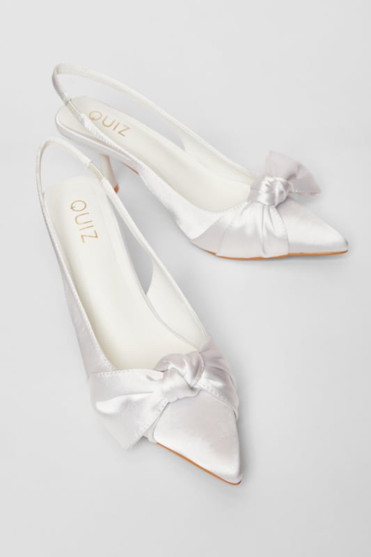 - Satin finish - Slingback strap - Bow detail - Pointed toe - Heel height: 9 cm / 3.5 inches approx - Excluding trims