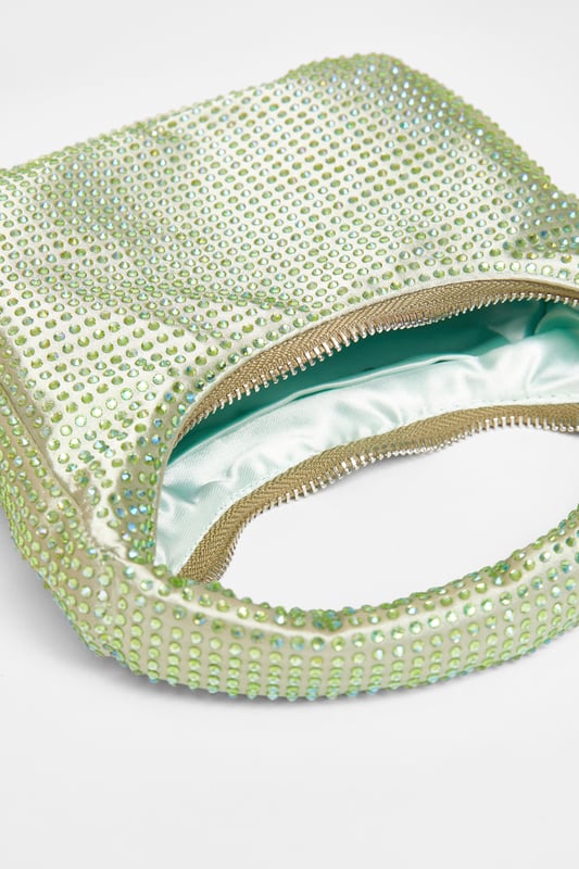 - Satin finish - Diamante embellished - Mini size - Top handle - Zip closure - Length: 20cm - Depth: 4cm - Height: 12cm approx