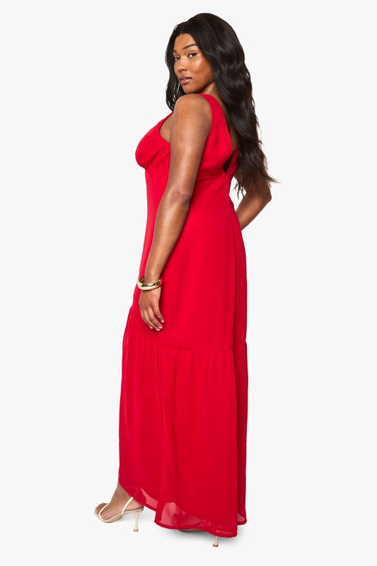 Flowing chiffon maxi dress with elegant patterned detailing
        Flattering V-neckline with gathered bust design
        Sleeveless silhouette with comfortable wide straps
        Dramatic front split for effortless movement
        Floor-sweeping length creates a graceful silhouette
    
    Make a striking impression at your next special occasion with this beautifully crafted chiffon maxi dress from Boohoo. The flowing fabric drapes elegantly around your curves, whilst the gathered bust and V-neckline create a feminine, flattering shape. The bold front split adds a touch of drama and allows for easy movement on the dance floor. Style with strappy metallic heels as shown and delicate gold jewellery to complete your look. Perfect for summer weddings, graduation ceremonies or race day events, this dress offers versatility and confidence in equal measure. The lightweight chiffon fabric ensures comfort throughout the day, whilst the patterned detailing adds visual interest to this showstopping piece. Accessorise with a small clutch bag and a sleek updo for maximum impact.