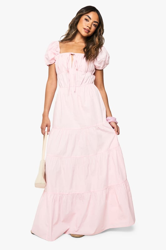 Cotton Poplin Tiered Maxi Dress Charming square neckline with delicate tie-front detail
Feminine puff sleeves for a romantic silhouette
Tiered maxi design creates beautiful movement and volume
Cotton poplin fabric offers breathable comfort for all-day wear
Flattering empire waistline that enhances your natural shape
This cotton poplin tiered maxi dress from Boohoo combines effortless style with day-long comfort. The dreamy silhouette features a square neckline and sweet puff sleeves that capture a romantic aesthetic perfect for summer days. Style with flat sandals and a woven tote for farmers' markets and brunch dates, or dress it up with espadrille wedges and statement earrings for garden parties and casual gatherings. The tiered design creates beautiful movement as you walk, while the breathable fabric keeps you cool during warmer weather. This versatile piece transitions seamlessly from daytime casual to evening relaxed events - simply switch your accessories to customise your look. Pair with a denim jacket for cooler evenings or wear alone to showcase the dress's beautiful structure and flow.