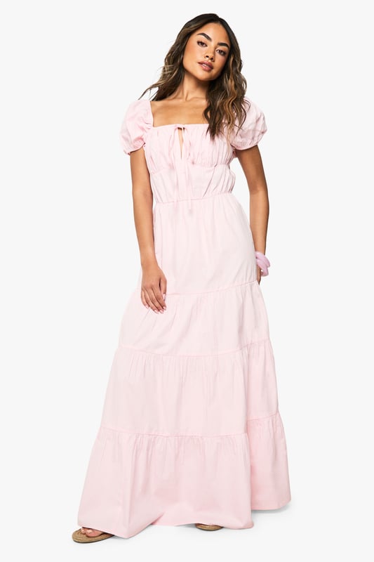 Cotton Poplin Tiered Maxi Dress Charming square neckline with delicate tie-front detail
Feminine puff sleeves for a romantic silhouette
Tiered maxi design creates beautiful movement and volume
Cotton poplin fabric offers breathable comfort for all-day wear
Flattering empire waistline that enhances your natural shape
This cotton poplin tiered maxi dress from Boohoo combines effortless style with day-long comfort. The dreamy silhouette features a square neckline and sweet puff sleeves that capture a romantic aesthetic perfect for summer days. Style with flat sandals and a woven tote for farmers' markets and brunch dates, or dress it up with espadrille wedges and statement earrings for garden parties and casual gatherings. The tiered design creates beautiful movement as you walk, while the breathable fabric keeps you cool during warmer weather. This versatile piece transitions seamlessly from daytime casual to evening relaxed events - simply switch your accessories to customise your look. Pair with a denim jacket for cooler evenings or wear alone to showcase the dress's beautiful structure and flow.
