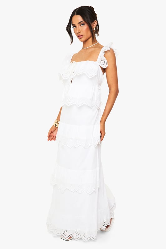 Petite Crochet Frill Maxi Dress Elegant crochet detailing with delicate scalloped edges throughout the tiered design
Feminine square neckline complemented by dainty ruffle straps
Flowing maxi length with romantic tiered ruffles for added movement
Petite-friendly proportions designed to flatter smaller frames
Intricate eyelet pattern adds texture and visual interest to this boho-inspired piece
This enchanting crochet maxi dress captures bohemian charm with its delicate ruffle details and tiered silhouette. The square neckline frames the dcolletage beautifully, while the lightweight fabric ensures comfort for all-day wear. Style with flat sandals and gold-toned bangles for casual daytime gatherings, or dress it up with espadrille wedges and statement earrings for garden parties. The versatile design transitions effortlessly from beachside strolls to family brunches. For cooler evenings, layer with a cropped denim jacket and add a woven clutch to complete the look. This Boohoo dress embodies carefree femininity whilst maintaining a contemporary edge-perfect for the fashion-forward woman who values both style and comfort in her wardrobe.