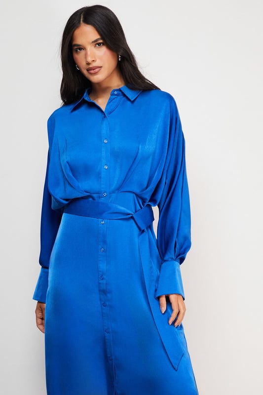 Striking batwing sleeves for a dramatic silhouette
        Elegant midi length with a daring side split
        Collared neckline adds a touch of sophistication
        Button-down front for versatile styling options
        Cinched waist design creates a flattering shape
    
    This satin shirt dress from Warehouse is a versatile piece that effortlessly transitions from day to night. The batwing sleeves create a bold, contemporary look, while the midi length with a side split adds a hint of allure. Perfect for confident women who appreciate edgy yet feminine styles, this dress can be styled for various casual occasions. For a chic daytime ensemble, pair it with ankle boots and a crossbody bag for a family lunch or weekend outing. Layer with a leather jacket for an edgier look when meeting friends for coffee. The button-down front allows for customisable coverage, making it suitable for different settings. Accessorise with statement earrings and a sleek updo for an evening dinner date. The dress's fluid silhouette and rich texture make it a standout piece in any wardrobe, ideal for those who want to make a subtle yet impactful fashion statement.
