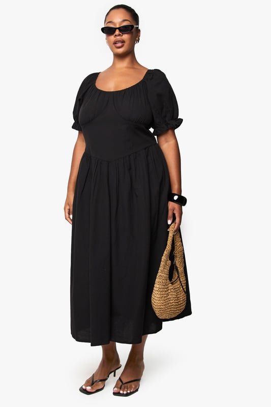 Crafted from breathable linen-look fabric, perfect for warm-weather comfort
        Feminine puff sleeves with delicate gathered detailing at the cuffs
        Flattering scoop neckline that frames the dcolletage beautifully
        Midi-length silhouette with a relaxed, flowing skirt that skims the body
        Gathered waist design creates a defined silhouette with effortless movement
    
    This versatile plus-size midi dress combines casual charm with timeless elegance. The linen-look fabric offers a natural texture that works brilliantly for daytime gatherings whilst maintaining a polished appearance. Style with flat sandals and a woven tote bag as shown for farmers' markets or weekend brunches. For garden parties, pair with espadrille wedges and statement earrings. The gathered waistline creates a flattering shape that works beautifully across body types, while the puff sleeves add a contemporary touch to this classic silhouette. This Boohoo dress transitions seamlessly from casual daywear to relaxed evening occasions - simply swap your accessories and add a denim jacket for cooler evenings. Perfect for holidays, family gatherings or casual Friday workwear when styled with a tailored blazer.