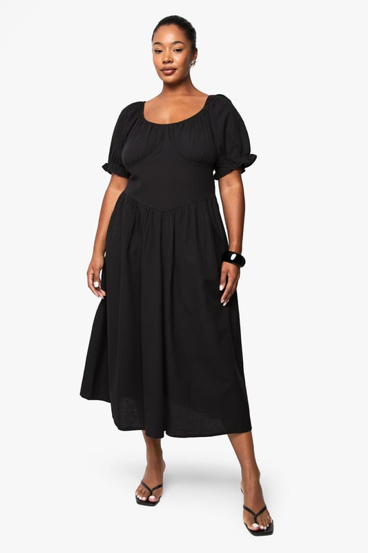Crafted from breathable linen-look fabric, perfect for warm-weather comfort
        Feminine puff sleeves with delicate gathered detailing at the cuffs
        Flattering scoop neckline that frames the dcolletage beautifully
        Midi-length silhouette with a relaxed, flowing skirt that skims the body
        Gathered waist design creates a defined silhouette with effortless movement
    
    This versatile plus-size midi dress combines casual charm with timeless elegance. The linen-look fabric offers a natural texture that works brilliantly for daytime gatherings whilst maintaining a polished appearance. Style with flat sandals and a woven tote bag as shown for farmers' markets or weekend brunches. For garden parties, pair with espadrille wedges and statement earrings. The gathered waistline creates a flattering shape that works beautifully across body types, while the puff sleeves add a contemporary touch to this classic silhouette. This Boohoo dress transitions seamlessly from casual daywear to relaxed evening occasions - simply swap your accessories and add a denim jacket for cooler evenings. Perfect for holidays, family gatherings or casual Friday workwear when styled with a tailored blazer.