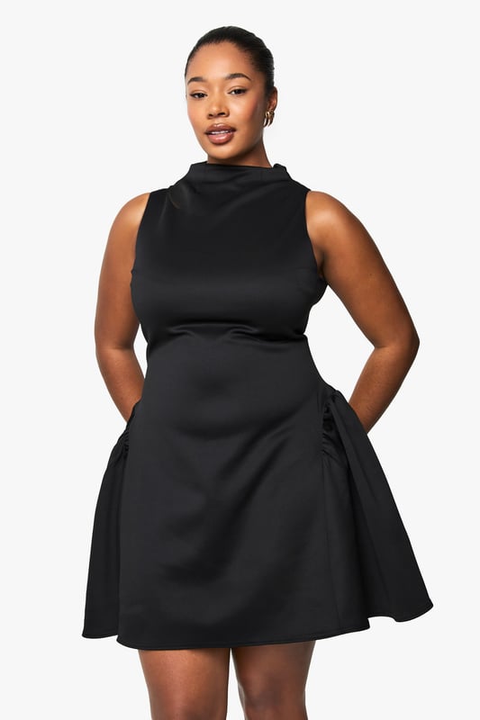 Structured scuba fabric creates a flattering silhouette that holds its shape beautifully
        High neckline with elegant mock-neck design adds sophistication
        Sleeveless cut showcases arms whilst maintaining a refined look
        Voluminous skater skirt creates dramatic movement and playful flair
        Back fastening ensures a smooth, streamlined front appearance
    
    Make a statement after dark in this structured skater dress that combines contemporary design with classic appeal. The mock-neck silhouette and sleeveless cut create a balanced look that's both modern and timeless, whilst the voluminous skirt adds dramatic flair to your night-out ensemble. Style with strappy heels and a compact clutch for drinks with the girls, or dress it up with statement jewellery and a bold cuff bracelet for club nights. The scuba fabric offers just the right amount of structure to maintain the dress's distinctive shape throughout the evening. This versatile piece transitions effortlessly from casual cocktails to more upscale venues-simply switch up your accessories to match the occasion. A true wardrobe hero for the fashion-forward woman who values both style and comfort for her night-time adventures.
