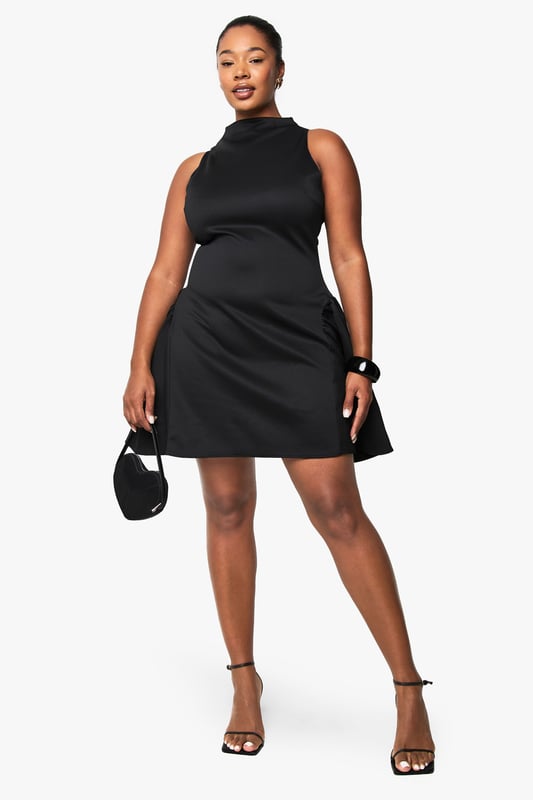 Structured scuba fabric creates a flattering silhouette that holds its shape beautifully
        High neckline with elegant mock-neck design adds sophistication
        Sleeveless cut showcases arms whilst maintaining a refined look
        Voluminous skater skirt creates dramatic movement and playful flair
        Back fastening ensures a smooth, streamlined front appearance
    
    Make a statement after dark in this structured skater dress that combines contemporary design with classic appeal. The mock-neck silhouette and sleeveless cut create a balanced look that's both modern and timeless, whilst the voluminous skirt adds dramatic flair to your night-out ensemble. Style with strappy heels and a compact clutch for drinks with the girls, or dress it up with statement jewellery and a bold cuff bracelet for club nights. The scuba fabric offers just the right amount of structure to maintain the dress's distinctive shape throughout the evening. This versatile piece transitions effortlessly from casual cocktails to more upscale venues-simply switch up your accessories to match the occasion. A true wardrobe hero for the fashion-forward woman who values both style and comfort for her night-time adventures.