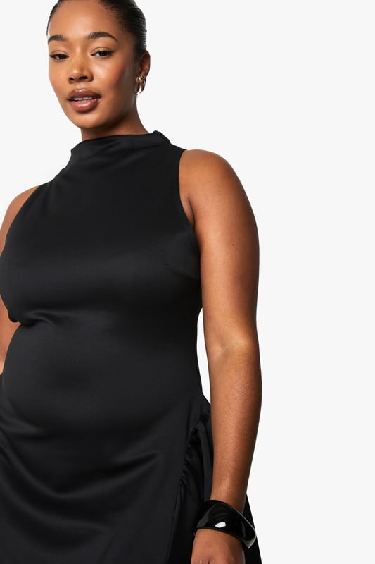 Structured scuba fabric creates a flattering silhouette that holds its shape beautifully
        High neckline with elegant mock-neck design adds sophistication
        Sleeveless cut showcases arms whilst maintaining a refined look
        Voluminous skater skirt creates dramatic movement and playful flair
        Back fastening ensures a smooth, streamlined front appearance
    
    Make a statement after dark in this structured skater dress that combines contemporary design with classic appeal. The mock-neck silhouette and sleeveless cut create a balanced look that's both modern and timeless, whilst the voluminous skirt adds dramatic flair to your night-out ensemble. Style with strappy heels and a compact clutch for drinks with the girls, or dress it up with statement jewellery and a bold cuff bracelet for club nights. The scuba fabric offers just the right amount of structure to maintain the dress's distinctive shape throughout the evening. This versatile piece transitions effortlessly from casual cocktails to more upscale venues-simply switch up your accessories to match the occasion. A true wardrobe hero for the fashion-forward woman who values both style and comfort for her night-time adventures.