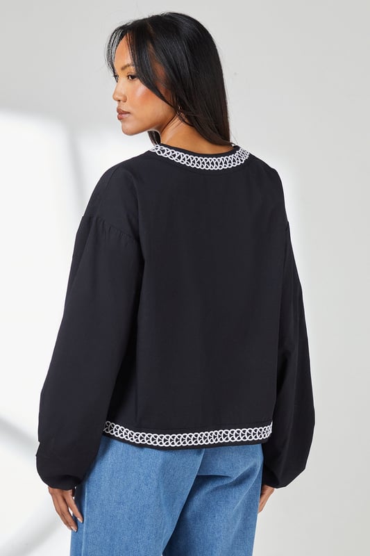 Embroidered Detail Blouse Distinctive embroidered trim along the V-neckline and hem adds artisanal character
Relaxed regular fit with voluminous balloon sleeves for contemporary silhouette
Crafted from pure cotton for breathable comfort throughout the day
Split V-neckline with subtle tie detail creates a flattering frame
Versatile woven design that transitions effortlessly from casual to smart-casual occasions
This Principles embroidered detail blouse combines timeless design with modern styling. The striking geometric embroidery creates a beautiful contrast against the woven fabric, whilst the relaxed silhouette ensures all-day comfort without compromising on style. Pair with wide-leg denim and flat sandals as seen on our model for a relaxed weekend look, perfect for farmers' markets or casual brunches. For a more polished daytime ensemble, try tucking the front into tailored trousers and adding a structured tote. The balloon sleeves add a touch of drama to this otherwise understated piece, making it ideal for family gatherings or informal work settings. This versatile blouse works beautifully with both light and dark bottoms, offering countless styling possibilities throughout the seasons.