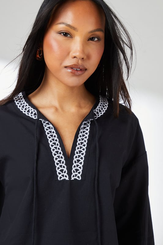 Embroidered Detail Blouse Distinctive embroidered trim along the V-neckline and hem adds artisanal character
Relaxed regular fit with voluminous balloon sleeves for contemporary silhouette
Crafted from pure cotton for breathable comfort throughout the day
Split V-neckline with subtle tie detail creates a flattering frame
Versatile woven design that transitions effortlessly from casual to smart-casual occasions
This Principles embroidered detail blouse combines timeless design with modern styling. The striking geometric embroidery creates a beautiful contrast against the woven fabric, whilst the relaxed silhouette ensures all-day comfort without compromising on style. Pair with wide-leg denim and flat sandals as seen on our model for a relaxed weekend look, perfect for farmers' markets or casual brunches. For a more polished daytime ensemble, try tucking the front into tailored trousers and adding a structured tote. The balloon sleeves add a touch of drama to this otherwise understated piece, making it ideal for family gatherings or informal work settings. This versatile blouse works beautifully with both light and dark bottoms, offering countless styling possibilities throughout the seasons.