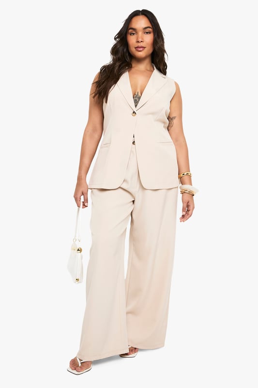 Sleeveless design with structured notched lapels for a sophisticated silhouette
        Single button fastening creates a flattering waistline definition
        Practical side pockets perfect for small essentials
        Versatile sleeveless cut ideal for layering or wearing alone
        Tailored fit with clean lines that complement curves beautifully
    
    This sleeveless blazer from Boohoo brings contemporary flair to your wardrobe staples. The clean-cut design offers endless styling possibilities-pair with the matching wide-leg trousers as seen on our model for a coordinated ensemble that works brilliantly for casual gatherings. For daytime outings, layer over a fitted tee with your favourite jeans and trainers. The sleeveless silhouette makes this piece particularly adaptable for transitional weather, allowing you to showcase statement jewellery while maintaining a polished appearance. For family gatherings, style with a silky camisole underneath and add metallic accessories for a touch of understated glamour. The versatile nature of this blazer ensures it will become a cornerstone in your capsule wardrobe, effortlessly taking you from casual brunches to smart-casual evening events with simple styling adjustments.