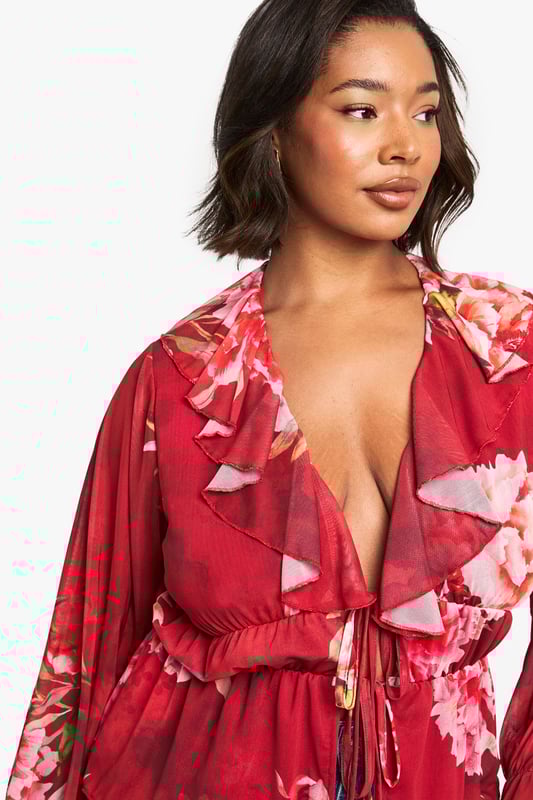 Floral peplum top with feminine ruffle detailing for added dimension
        Plunging V-neckline with cascading ruffle trim that frames the dcolletage
        Flattering elasticated waist with front tie closure for an adjustable fit
        Statement bell sleeves with pleated cuffs for a dramatic silhouette
        Lightweight jersey fabric that drapes beautifully for all-day comfort
    
    Make a striking impression with this boohoo floral peplum top that combines romantic details with contemporary styling. The ruffle-trimmed V-neckline creates a flattering frame for your dcolletage, while the peplum silhouette cinches at the waist before gently flaring out to complement your curves. Style with wide-leg denim jeans as shown for a balanced casual look, or dress it up with tailored trousers and heels for evening drinks. The statement bell sleeves add a touch of drama to this versatile piece, making it perfect for family gatherings or weekend brunches. Complete your ensemble with minimal jewellery and a small handbag to let the top's beautiful design take centre stage. This top effortlessly transitions from day to night, offering both comfort and style for the fashion-forward woman.