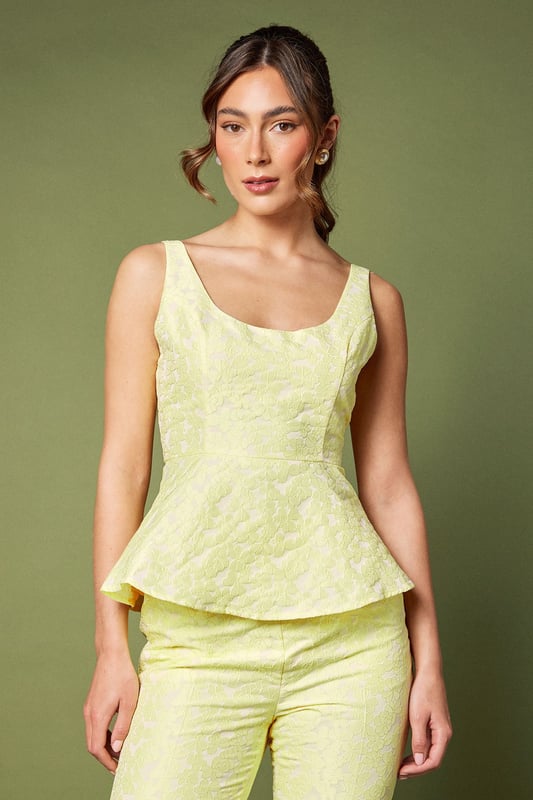 Elegant sleeveless design with sophisticated jacquard texture
        Flattering peplum silhouette that accentuates the waistline
        Refined square neckline for a contemporary touch
        Structured bodice with subtle shaping for a polished look
        Fully lined for comfort and a smooth finish
    
    This exquisite jacquard peplum top from Coast embodies refined elegance for your special occasions. The structured bodice with its contemporary square neckline creates a flattering frame for your dcolletage, whilst the peplum detail gracefully highlights the waist for a feminine silhouette. As shown, pair with coordinating trousers for a sophisticated co-ord ensemble perfect for summer weddings or race day events. Alternatively, style with a tailored pencil skirt and strappy heels for evening soires. Complete your look with delicate jewellery and a clutch bag for occasions where making an impression matters. The versatile design transitions beautifully from formal daytime events to elegant evening gatherings, making it a valuable addition to your occasion wardrobe.