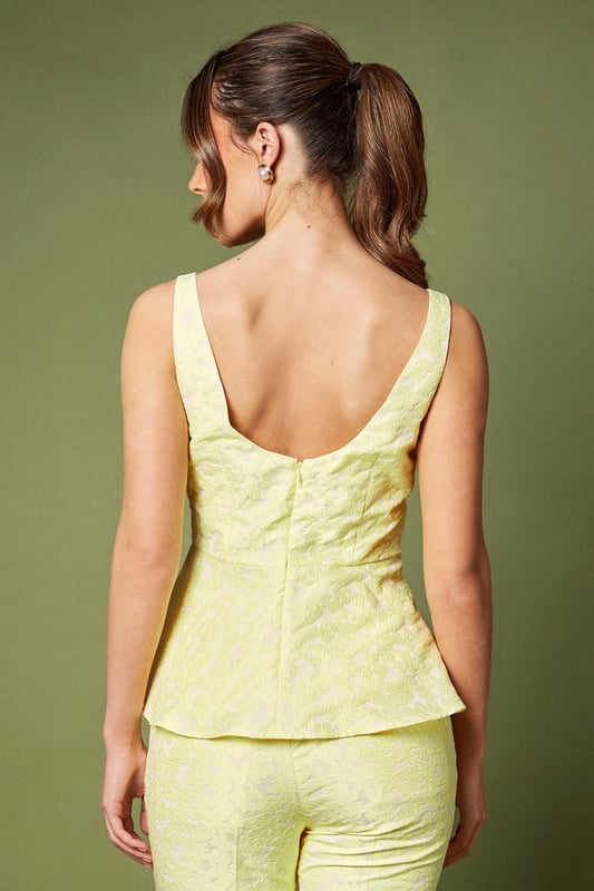 Elegant sleeveless design with sophisticated jacquard texture
        Flattering peplum silhouette that accentuates the waistline
        Refined square neckline for a contemporary touch
        Structured bodice with subtle shaping for a polished look
        Fully lined for comfort and a smooth finish
    
    This exquisite jacquard peplum top from Coast embodies refined elegance for your special occasions. The structured bodice with its contemporary square neckline creates a flattering frame for your dcolletage, whilst the peplum detail gracefully highlights the waist for a feminine silhouette. As shown, pair with coordinating trousers for a sophisticated co-ord ensemble perfect for summer weddings or race day events. Alternatively, style with a tailored pencil skirt and strappy heels for evening soires. Complete your look with delicate jewellery and a clutch bag for occasions where making an impression matters. The versatile design transitions beautifully from formal daytime events to elegant evening gatherings, making it a valuable addition to your occasion wardrobe.