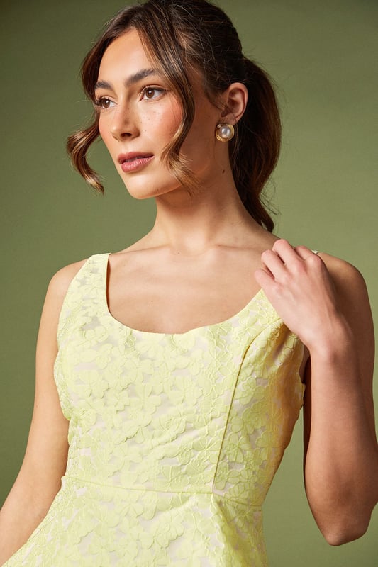 Elegant sleeveless design with sophisticated jacquard texture
        Flattering peplum silhouette that accentuates the waistline
        Refined square neckline for a contemporary touch
        Structured bodice with subtle shaping for a polished look
        Fully lined for comfort and a smooth finish
    
    This exquisite jacquard peplum top from Coast embodies refined elegance for your special occasions. The structured bodice with its contemporary square neckline creates a flattering frame for your dcolletage, whilst the peplum detail gracefully highlights the waist for a feminine silhouette. As shown, pair with coordinating trousers for a sophisticated co-ord ensemble perfect for summer weddings or race day events. Alternatively, style with a tailored pencil skirt and strappy heels for evening soires. Complete your look with delicate jewellery and a clutch bag for occasions where making an impression matters. The versatile design transitions beautifully from formal daytime events to elegant evening gatherings, making it a valuable addition to your occasion wardrobe.