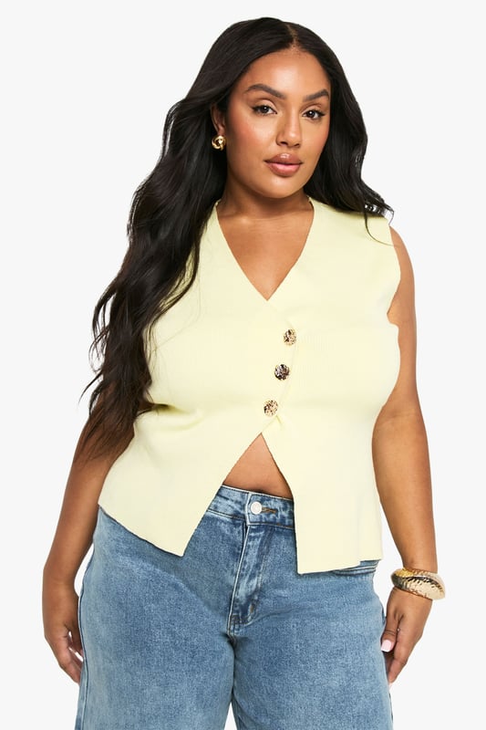 Asymmetrical knitted waistcoat with distinctive gold-tone button detailing
        Sleeveless design with a flattering V-neckline
        Structured silhouette that creates a contemporary profile
        Versatile length that works perfectly with high-waisted bottoms
        Inclusive plus size fit designed to complement your curves
    
    This striking asymmetrical waistcoat brings a modern twist to your casual collection. The knitted fabric offers just the right amount of structure whilst maintaining comfort for all-day wear. Style with your favourite high-waisted jeans as shown for a relaxed daytime look, or dress up with tailored wide-leg trousers for more polished occasions. The gold-tone buttons add a touch of sophistication that catches the light beautifully. Perfect for family gatherings or brunches with friends, this Boohoo piece transitions effortlessly from day to evening - simply swap your trainers for block heels and add statement jewellery. The versatile design allows for layering in cooler months or wearing alone as a statement piece when temperatures rise.