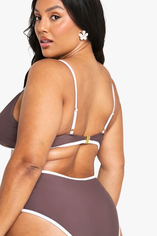 Balconette style bikini top with flattering lift and support
        Contrasting trim detail along edges for a striking visual effect
        Adjustable shoulder straps with gold-tone hardware for a customised fit
        Deep V-neckline creates an elegant silhouette
        High-waisted matching bottoms complete the coordinated set
    
    Make a statement poolside with this Plus Kontrast Balconette Bikini Top from Boohoo. The sophisticated balconette design offers excellent support whilst creating a beautifully defined shape. The contrasting trim adds a contemporary twist to this classic swimwear piece, making it perfect for those who want to stand out at the beach club. Pair with the matching high-waisted bottoms for a cohesive look, or mix with plain bottoms for versatility. This bikini is ideal for everything from lounging by the pool to beach volleyball with friends. Add oversized sunglasses and a wide-brimmed hat for ultimate holiday glamour, or layer under a sheer kaftan when heading to beachside lunch. The adjustable straps ensure comfort throughout the day, no matter your activity of choice.