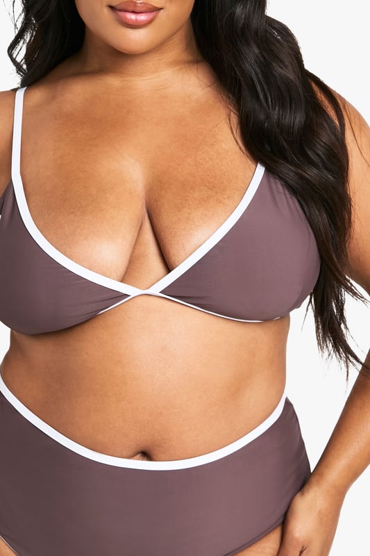 Balconette style bikini top with flattering lift and support
        Contrasting trim detail along edges for a striking visual effect
        Adjustable shoulder straps with gold-tone hardware for a customised fit
        Deep V-neckline creates an elegant silhouette
        High-waisted matching bottoms complete the coordinated set
    
    Make a statement poolside with this Plus Kontrast Balconette Bikini Top from Boohoo. The sophisticated balconette design offers excellent support whilst creating a beautifully defined shape. The contrasting trim adds a contemporary twist to this classic swimwear piece, making it perfect for those who want to stand out at the beach club. Pair with the matching high-waisted bottoms for a cohesive look, or mix with plain bottoms for versatility. This bikini is ideal for everything from lounging by the pool to beach volleyball with friends. Add oversized sunglasses and a wide-brimmed hat for ultimate holiday glamour, or layer under a sheer kaftan when heading to beachside lunch. The adjustable straps ensure comfort throughout the day, no matter your activity of choice.