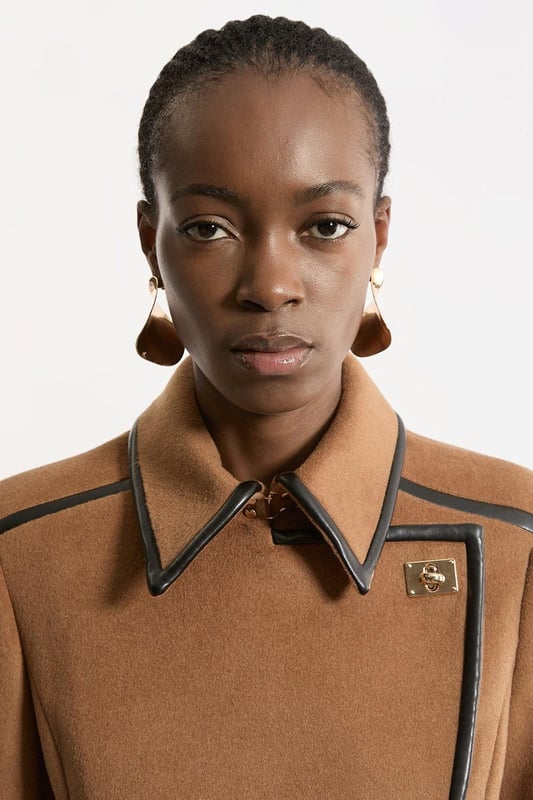Fall '24: Allow our latest collection of autumn pieces to inspire you for the season ahead. Feel elevated no matter the weather in our midi length coat, made in high quality, thick wool, featuring a fit that flatters the figure and faux leather trims. Wear it over any outfit, whether heading out for dinner or to the office. Wool Blend Faux Leather Trim Belted Tailored Coat High Quality Wool Blend Fabric Flattering Fitted Bodice Straight Hanging Skirt Metallic Clasp Buttons at Collar and Cuffs High, Collared Neckline Belted Waistline Unique, Faux Leather TrimsShop this seasons belted coats and jackets or browse the full collection of coats and jackets now.