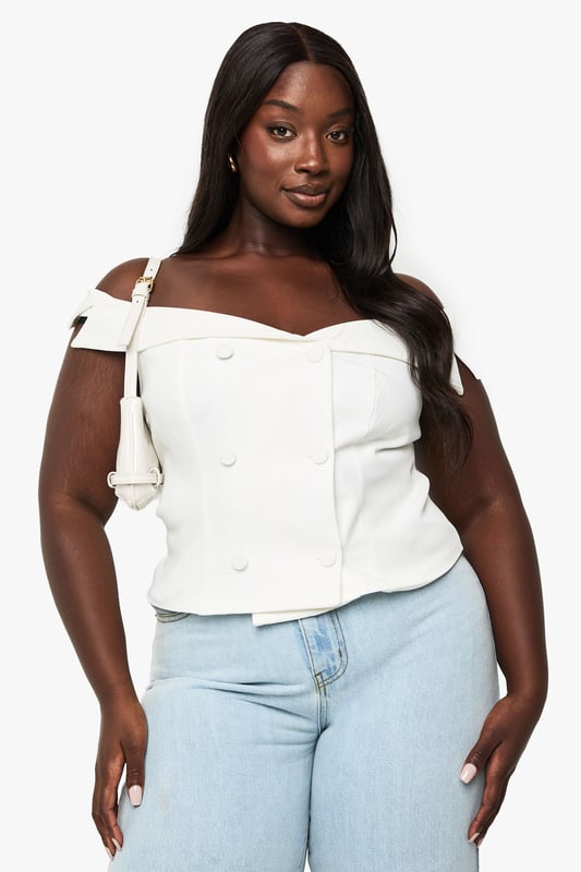 Elegant off-shoulder design with a sweetheart neckline for a flattering silhouette
        Structured bodice with decorative button detailing down the front
        Chic fold-over bardot style neckline that showcases the dcolletage
        Versatile cropped length perfect for high-waisted bottoms
        Tailored fit that accentuates your curves whilst providing comfort
    
    This sophisticated off-shoulder top brings a touch of glamour to your occasion wardrobe. The structured bodice with its elegant button detailing creates a refined look that commands attention at formal gatherings. Style with high-waisted tailored trousers and strappy heels for graduation ceremonies or summer weddings, or pair with a flowing midi skirt for race day elegance. The versatile design works brilliantly with statement jewellery - try layered necklaces or dramatic earrings to complement the clean neckline. For cooler evenings, drape a lightweight blazer over your shoulders without compromising the beautiful bardot detail. This Boohoo piece transitions effortlessly from daytime events to evening soires, making it an essential addition to your occasion collection.