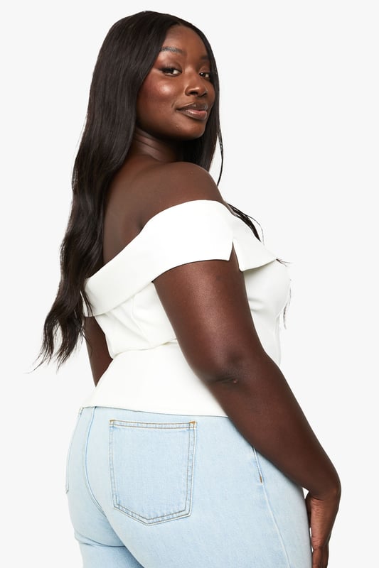 Elegant off-shoulder design with a sweetheart neckline for a flattering silhouette
        Structured bodice with decorative button detailing down the front
        Chic fold-over bardot style neckline that showcases the dcolletage
        Versatile cropped length perfect for high-waisted bottoms
        Tailored fit that accentuates your curves whilst providing comfort
    
    This sophisticated off-shoulder top brings a touch of glamour to your occasion wardrobe. The structured bodice with its elegant button detailing creates a refined look that commands attention at formal gatherings. Style with high-waisted tailored trousers and strappy heels for graduation ceremonies or summer weddings, or pair with a flowing midi skirt for race day elegance. The versatile design works brilliantly with statement jewellery - try layered necklaces or dramatic earrings to complement the clean neckline. For cooler evenings, drape a lightweight blazer over your shoulders without compromising the beautiful bardot detail. This Boohoo piece transitions effortlessly from daytime events to evening soires, making it an essential addition to your occasion collection.