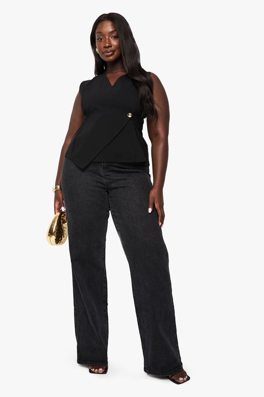 Sleeveless wrap design with sophisticated V-neckline
        Elegant gold-tone button detail at the waist for a touch of glamour
        Flattering asymmetric wrap front that creates visual interest
        Structured silhouette that enhances your curves
        Versatile sleeveless style perfect for layering or wearing alone
    
    Make a statement in this chic wrap waistcoat that combines sophistication with contemporary style. The asymmetric design with its distinctive gold button detail creates a flattering silhouette that works wonderfully for evening occasions. Style with wide-leg trousers as shown for a polished night-out ensemble, or pair with a fitted skirt for an alternative look that commands attention. Add statement gold jewellery to complement the luxe button detail and finish with strappy heels for drinks with the girls. This versatile piece transitions effortlessly from after-work cocktails to weekend club nights, ensuring you stand out for all the right reasons. The sleeveless design also makes it ideal for warmer evenings or layering under a tailored blazer when the temperature drops.
