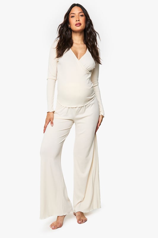 Maternity Brushed Rib Wrap Lettuce Hem Top & Trouser Lounge Set Ribbed wrap-style top with elegant ruched hem detail for added texture
Flattering V-neckline that provides comfortable nursing access
Long sleeves for extra warmth during night-time or lounging
Wide-leg trousers with relaxed fit for unrestricted movement
Specially designed to accommodate and flatter your changing shape throughout pregnancy
Embrace comfort without compromising on style with this versatile maternity loungewear set from Boohoo. The thoughtfully designed wrap top features a feminine V-neckline and ruched hem that gently contours your bump, while the soft ribbed fabric moves with your body. The coordinating wide-leg trousers offer the perfect balance of comfort and contemporary style, making this set ideal for relaxing evenings at home or catching up on much-needed rest. Pair with fluffy slippers and a lightweight dressing gown for cooler evenings, or simply enjoy the set on its own during warmer months. This loungewear duo transitions effortlessly from pregnancy to nursing, ensuring you'll enjoy this Boohoo essential long after your little one arrives.