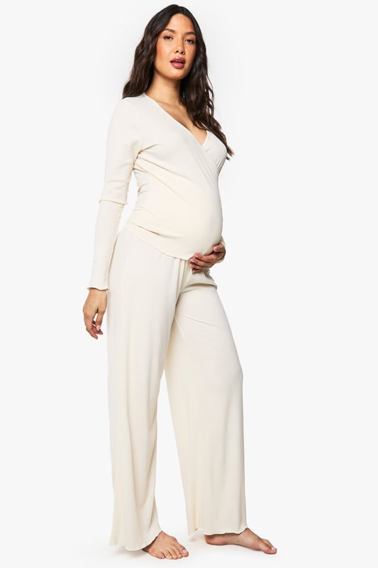 Maternity Brushed Rib Wrap Lettuce Hem Top & Trouser Lounge Set Ribbed wrap-style top with elegant ruched hem detail for added texture
Flattering V-neckline that provides comfortable nursing access
Long sleeves for extra warmth during night-time or lounging
Wide-leg trousers with relaxed fit for unrestricted movement
Specially designed to accommodate and flatter your changing shape throughout pregnancy
Embrace comfort without compromising on style with this versatile maternity loungewear set from Boohoo. The thoughtfully designed wrap top features a feminine V-neckline and ruched hem that gently contours your bump, while the soft ribbed fabric moves with your body. The coordinating wide-leg trousers offer the perfect balance of comfort and contemporary style, making this set ideal for relaxing evenings at home or catching up on much-needed rest. Pair with fluffy slippers and a lightweight dressing gown for cooler evenings, or simply enjoy the set on its own during warmer months. This loungewear duo transitions effortlessly from pregnancy to nursing, ensuring you'll enjoy this Boohoo essential long after your little one arrives.
